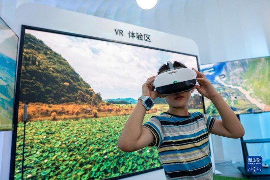 8月18日，一名孩子在第七届中国—南亚博览会上体验VR设备。
