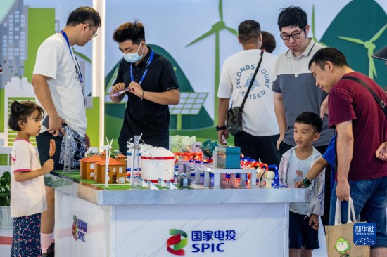 8月19日，在第七届中国—南亚博览会国家电投展区，家长带着孩子参观展览。